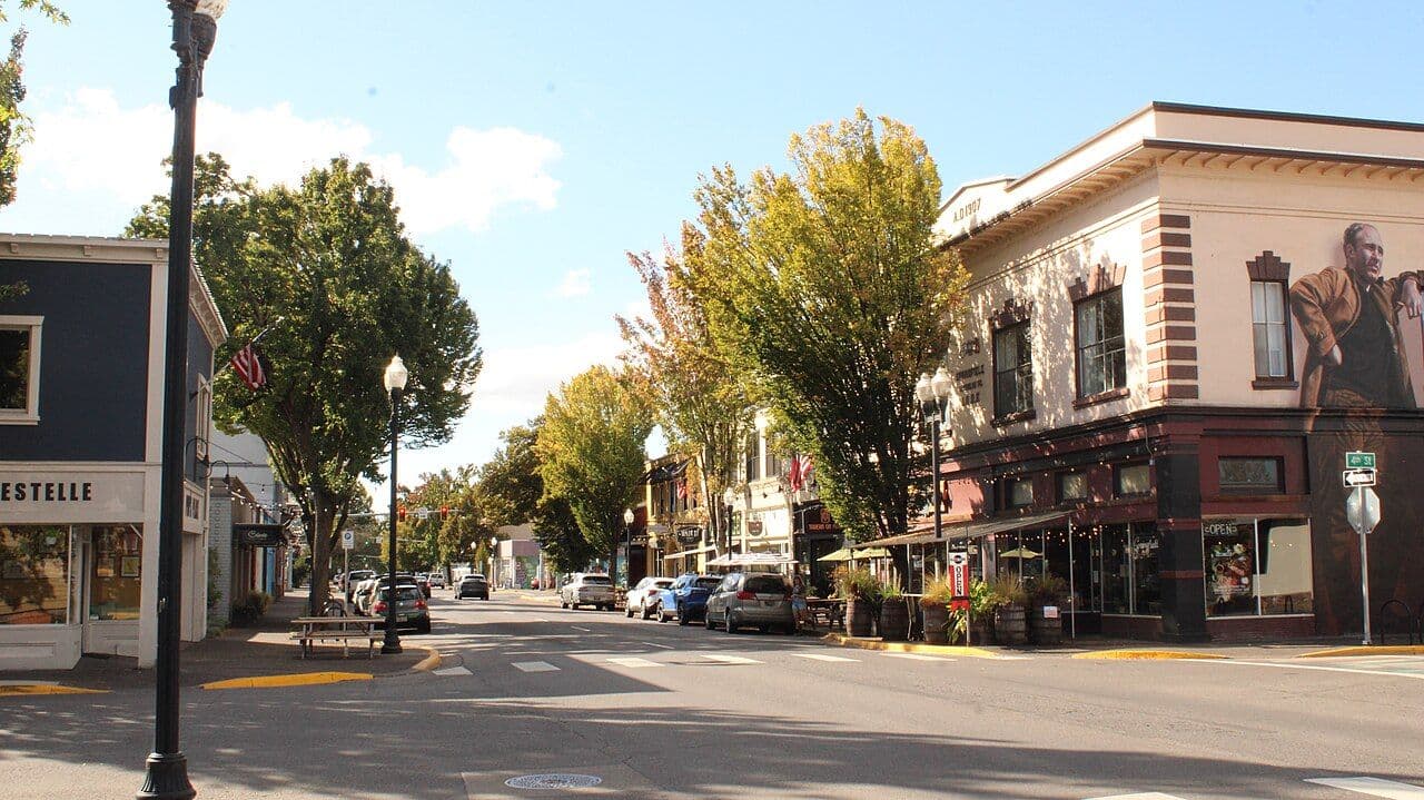 Main Street in downtown Springfield, lined with trees and historic storefronts.